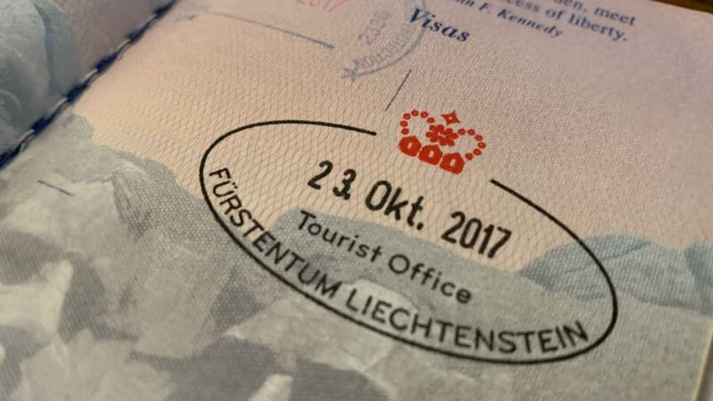 black and red Liechtenstein stamp in a passport - Things to do in Liechtenstein