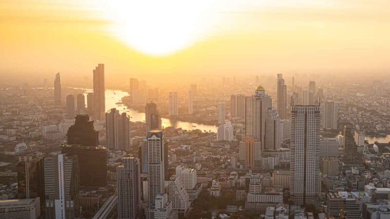 Golden sunset over the city of Bangkok viewed from a rooftop Sky Bar