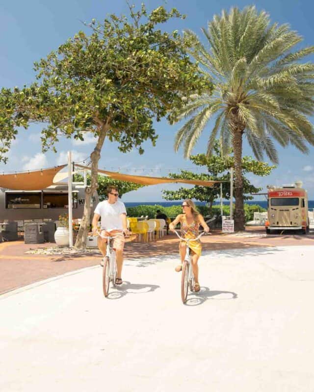 couple riding bikes at Sandals Resorts