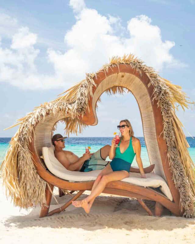 Couple in a Heart shaped beach loungers at Sandals Curacao 